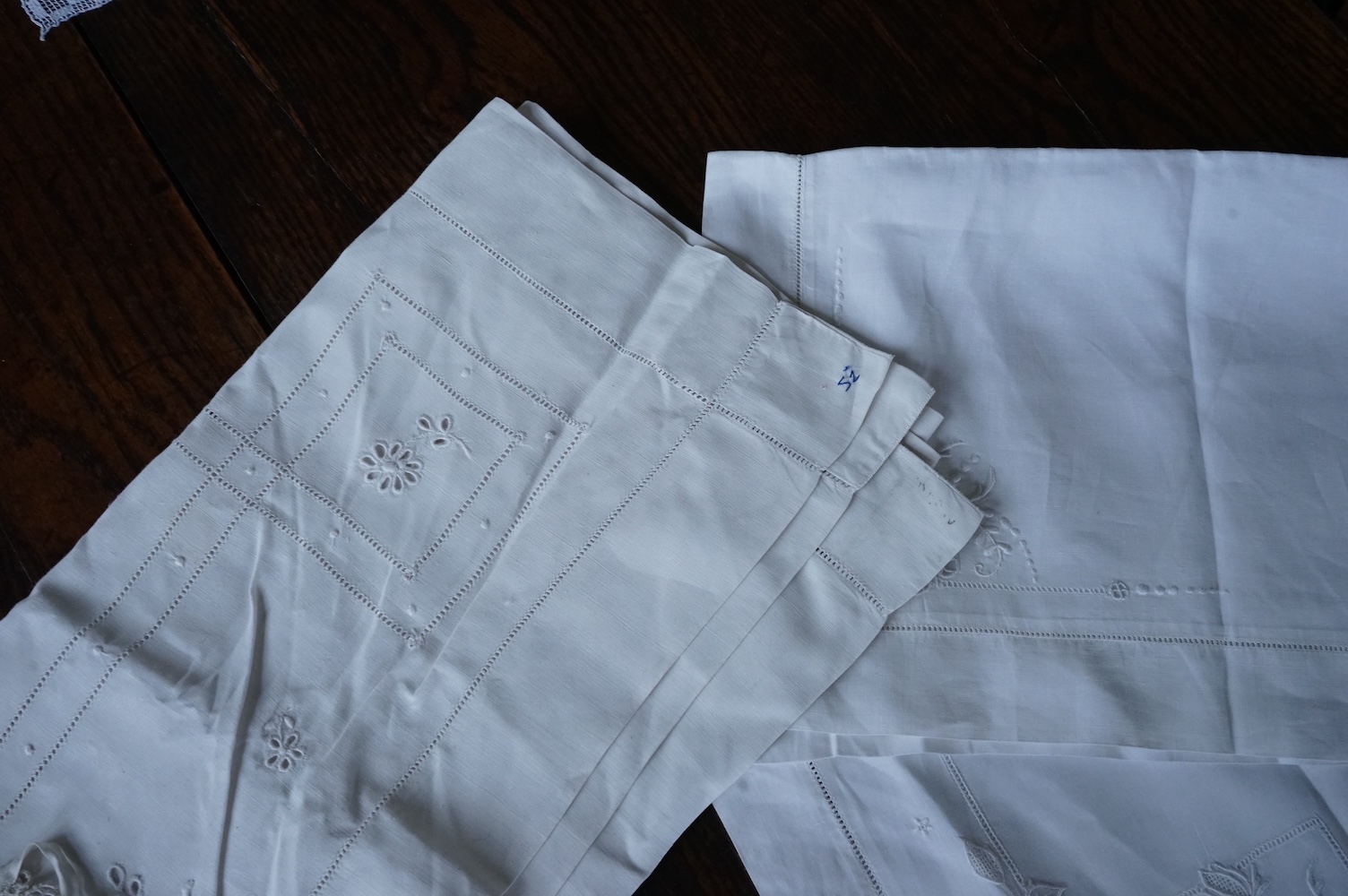 Ten fine linen baby’s pillowcases, eight inset and edged with fillet lace, together with a large fine linen red bordered 19th century ladies kerchief, and three other items. (14) Kerchief 54cm x 58cm. Condition - all ite
